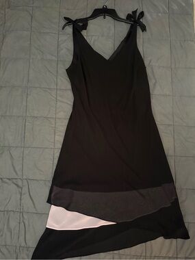 Black and light pink asymmetrical dress with bow detail. Size: 16